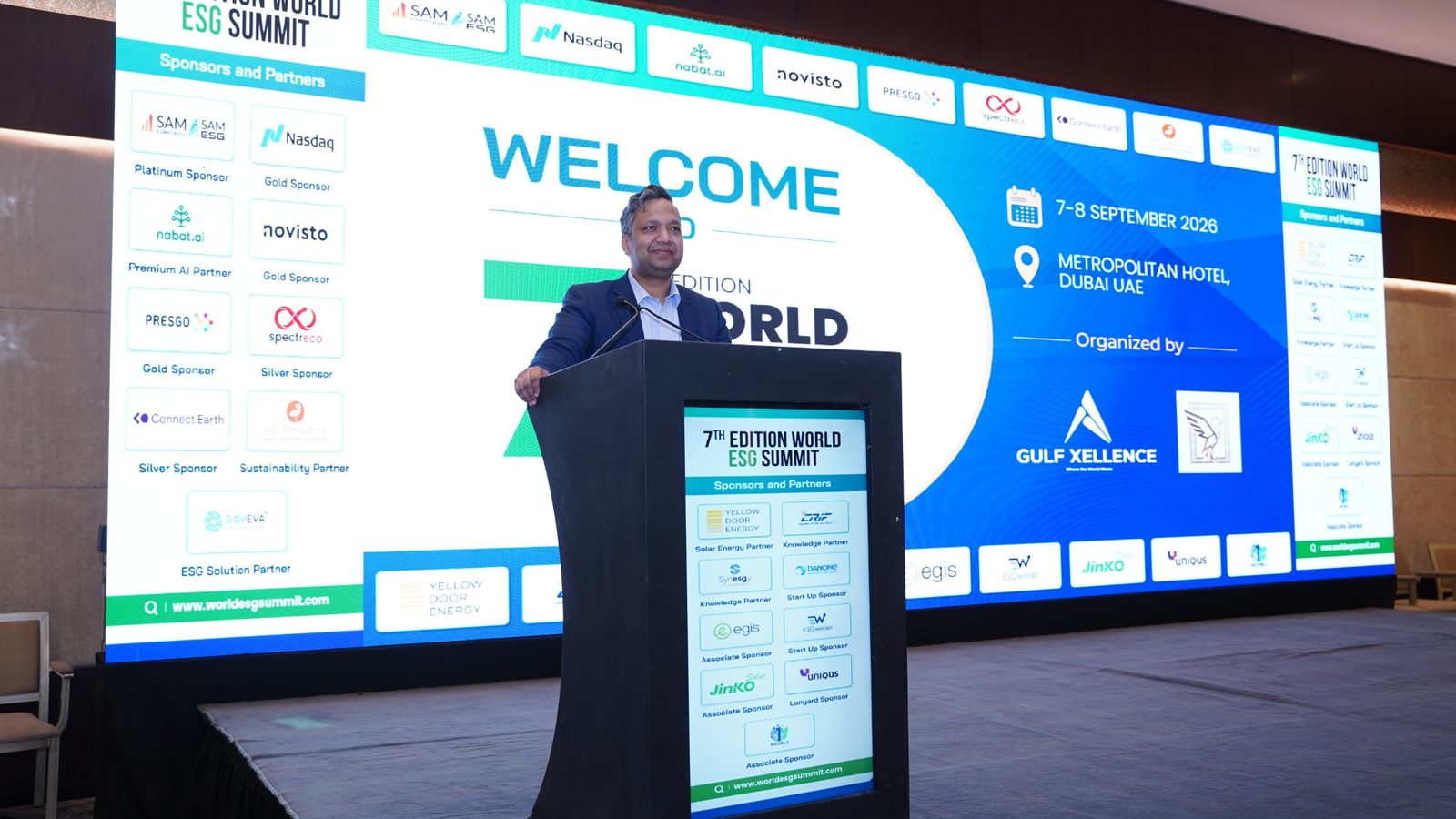 Sumit Agarwal at the podium in front of the World ESG Summit welcome screen